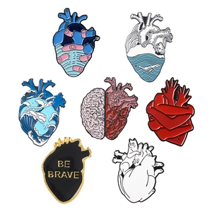 Collection of seven artistic heart-shaped enamel pins featuring whale, cat, and brain designs