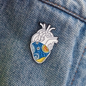 Artistic anatomical heart pin featuring Starry Night painting details on denim