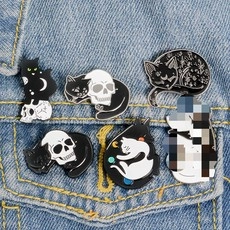 Detail of whimsical cat enamel pins set featuring crescent moon and mystic motifs on denim
