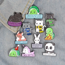 Collection of funny animal enamel pins with witty text displayed on denim fabric background