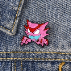 Detail of a purple ghost enamel pin with glitter finish pinned on blue denim jacket
