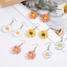 Detail of colorful daisy drop earrings set featuring vibrant orange, white, and pink floral designs