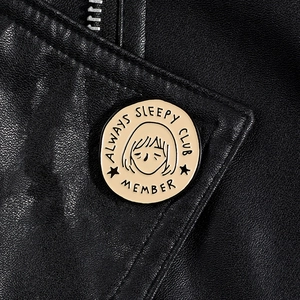 Always Sleepy Club Member enamel pin badge pinned on a black leather jacket texture
