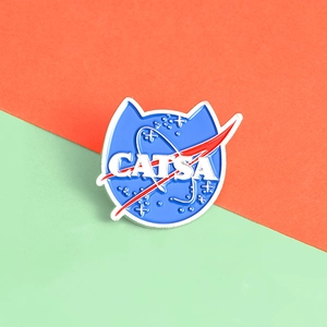 Funny blue CATSA enamel pin with space logo parody design and cat ear shape on split background