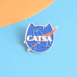 Detailed close-up of blue enamel cat head badge with CATSA logo and silver metal edges