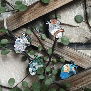 Creative anatomical heart enamel pins set with ocean, rose, butterfly and Van Gogh motifs