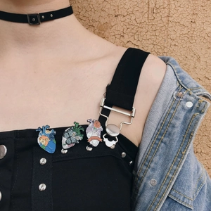 Artistic enamel heart pins featuring Van Gogh motifs, butterflies and roses on a jacket