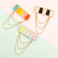 Three-piece set of gummy bear brooch pins with triple layered gold chains and resin bears