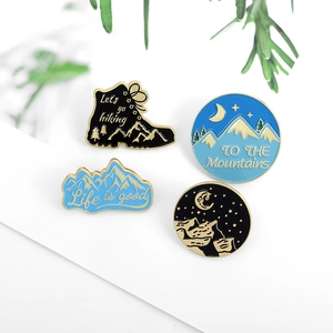 Set of 4 hiking enamel pins with outdoor mountain and boot designs for travel gear