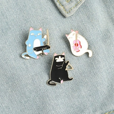 Three-piece enamel cat band brooches with piano, violin, and triangle on denim background