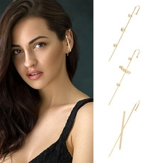 Detailed view of three gold-plated ear cuff designs with sparkling cubic zirconia inlay