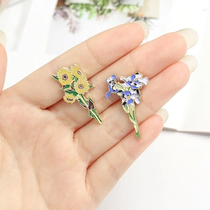 Artistic enamel brooches featuring Van Gogh sunflower and iris flower design on hand