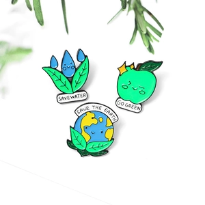 Three-piece eco-friendly enamel pin set featuring water drop, green apple, and earth designs