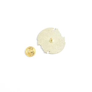 Back view of gold animal badge with butterfly clutch fastener on white background