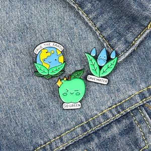 Eco-friendly enamel pin set with Save the Earth and Save Water slogans on denim