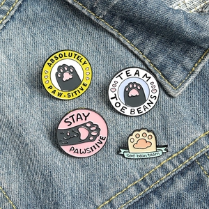 Cartoon cat paw enamel pins set for backpacks with cute paw prints and funny puns