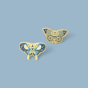 Elegant butterfly enamel pins set with celestial sun moon patterns and gold plating