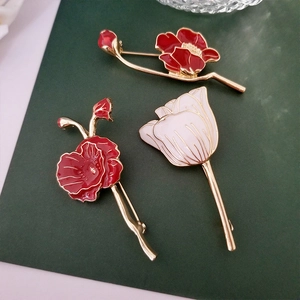 Elegant floral brooches with red poppy and white tulip designs in gold finish