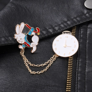 Detailed view of Alice in Wonderland style rabbit and clock brooch on a leather jacket