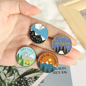Set of four colorful enamel mountain pins with Happy Campers and outdoor camping slogans