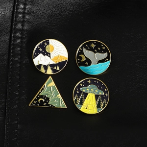 Set of 4 enamel pins featuring whale tail mountain and UFO designs with gold metal edges