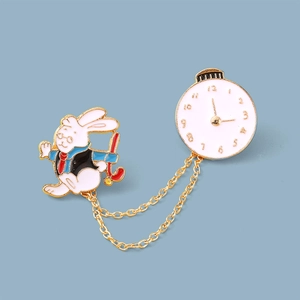 Detailed view of Alice in Wonderland rabbit brooch with gold chain and clock charm