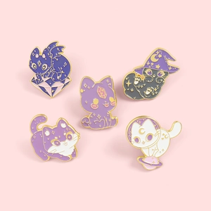 Set of five cartoon cat enamel pins featuring wizard and astronaut designs on pink background