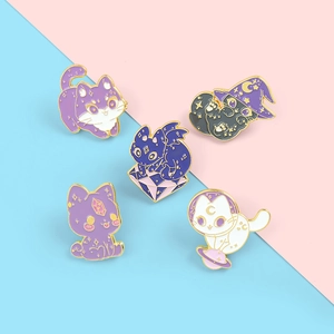 Macro detail of five whimsical cartoon enamel cat brooches with gold cosmic accents