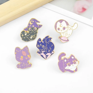 Detailed view of wizard and space cat enamel pins with gold edges and fantasy elements