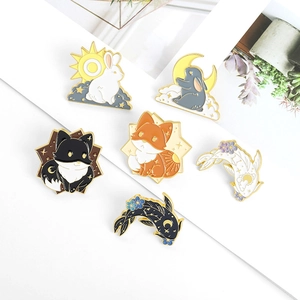 Detail of six enamel pins featuring cute cartoon rabbits, foxes, and koi fish designs