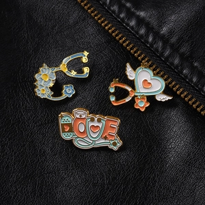 Detailed view of medical enamel pins with stethoscope heart and love motifs on black leather