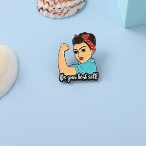 Detailed close-up of a metal enamel nurse brooch featuring Be Your Best Self text and design