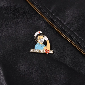 Close-up of Nurse Strong enamel pin on a black leather jacket featuring a female nurse