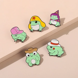 Set of five cute cartoon frog enamel pins in colorful hats for creative accessory styling