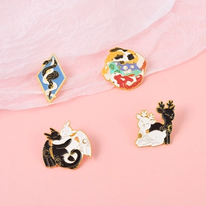 Set of four artistic alloy enamel pins with animal and yin-yang designs on pink background