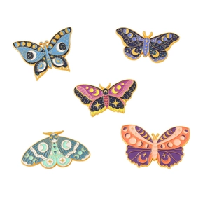 Colorful butterfly and moth enamel pins set with celestial moon and star motifs