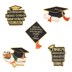 Macro view of five piece graduation enamel pin set with cap and diploma details