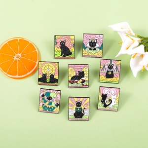 Detailed flat lay of eight black cat tarot enamel pins featuring Empress and Lovers cards