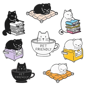 Close-up of eight cute enamel pins featuring cats with coffee cups and books