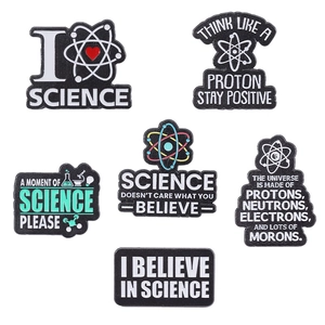 Set of 6 science enamel pins featuring microscopes and atom models on white background
