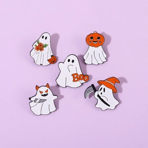 Close-up detail of five cartoon ghost enamel pins for Halloween with various spooky props