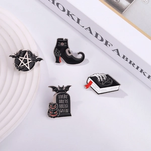 Dark gothic alloy enamel pins featuring witch boots and gravestone on minimalist background