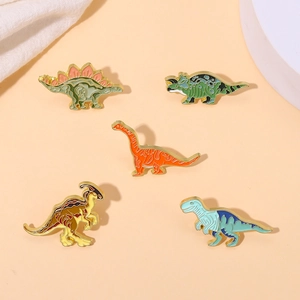 Detailed view of 5-piece set cartoon dinosaur enamel pins with colorful lacquer finish