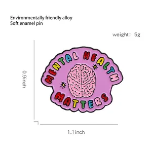 Pink brain enamel pin with Mental Health Matters lettering in eco-friendly alloy
