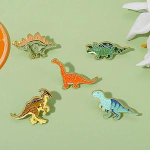 Set of 5 colorful enamel dinosaur pins featuring stegosaurus and triceratops with gold edges