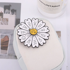 Creative rotating daisy enamel pin badge featuring YES NO text on a canvas bag