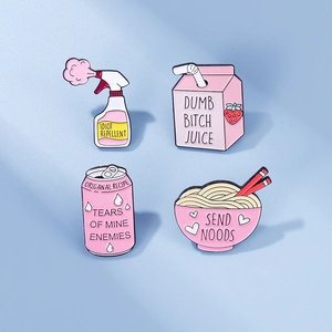 Close-up of four pink enamel pins featuring humorous soda cans and ramen bowl designs
