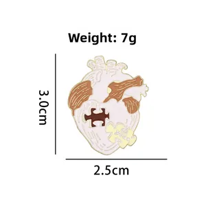 Detail of creative heart enamel pin with puzzle piece feature and you text engraving