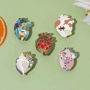 Macro detail of five creative enamel heart pins featuring artistic oil painting patterns