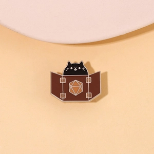 Enamel pin detail of a black cat hiding behind a brown D20 screen for game lovers